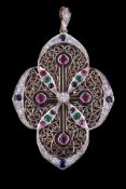 A diamond, ruby, sapphire and emerald pendant, the quatrefoil panel with pierced scroll decoration