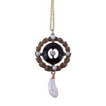 An early 20th century diamond, seed pearl and onyx pendant, the central old brilliant cut diamond
