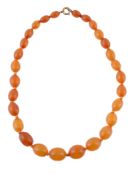 An amber bead necklace, the single strand necklace composed of graduating 1cm to 1.5cm amber beads,