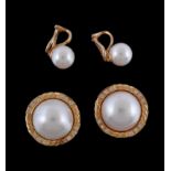 A pair of mabe pearl and diamond earrings, the mabe pearl within a twisting surround set with