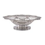 A late Victorian silver shaped oval pedestal basket by Charles Stuart Harris, London 1898, the
