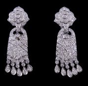 A pair of diamond earrings, the flower head surmount set throughout with brilliant cut diamonds,