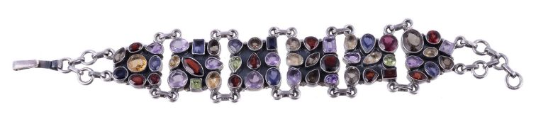A multi gem set bracelet, the panels set with vari cut amethysts, citrines, garnets, peridot and