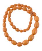 An amber bead necklace, the single strand composed of graduating 1.3cm to 2.4cm amber beads, to a