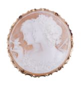 A shell cameo brooch, the circular brooch carved with the profiles of two Bacchantae, within a