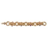 An 18 carat gold ruby and sapphire bracelet, the hollow links with polished batons set with