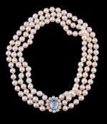A triple row cultured pearl necklace, the uniform cultured pearls on a knotted strings, the clasp