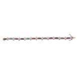 A multi gem set bracelet, with alternating panels channel set with rubies, emeralds or sapphires,