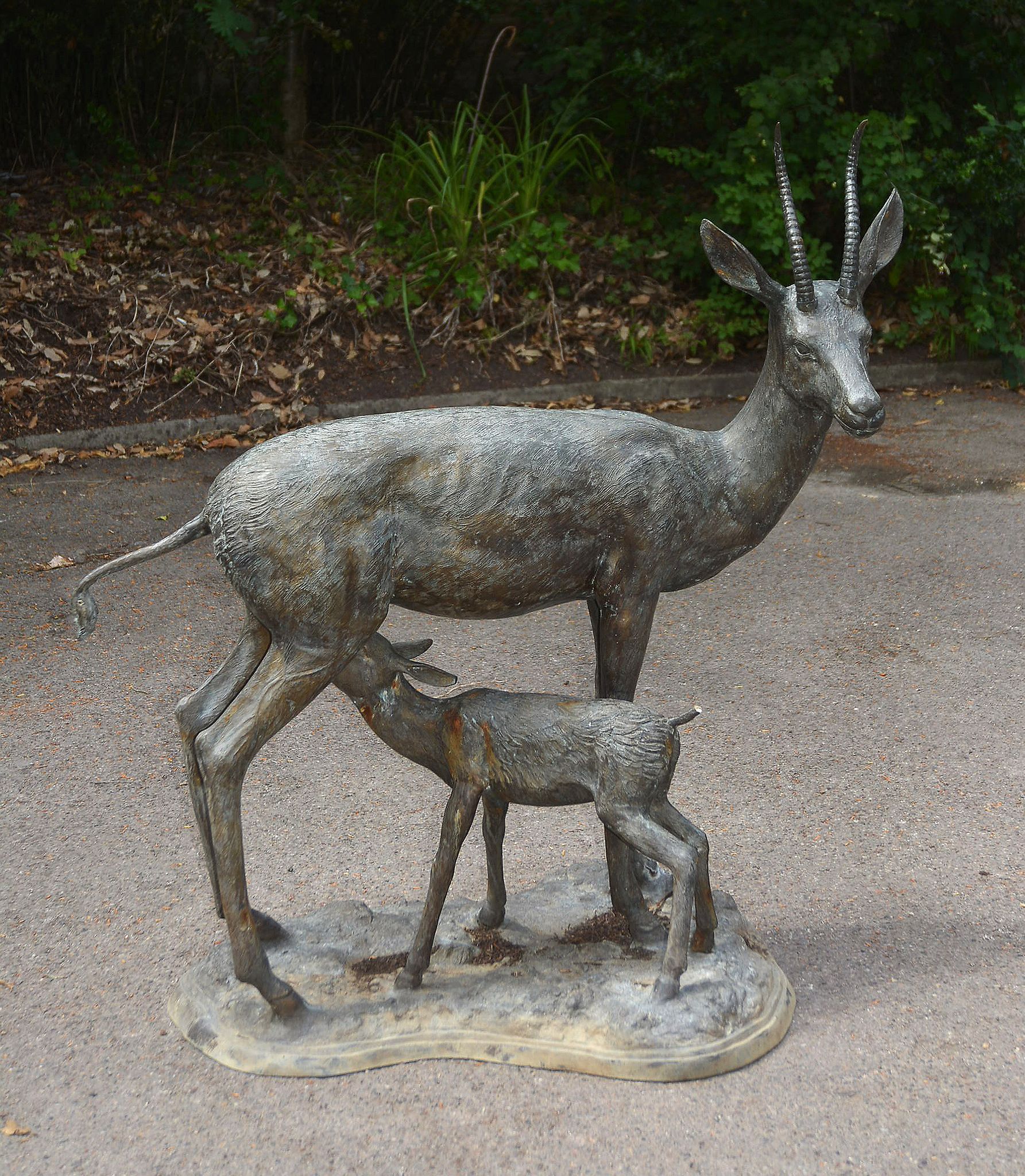 A bronze alloy garden group of a springbok doe and a fawn, circa 2000 A bronze alloy garden group of