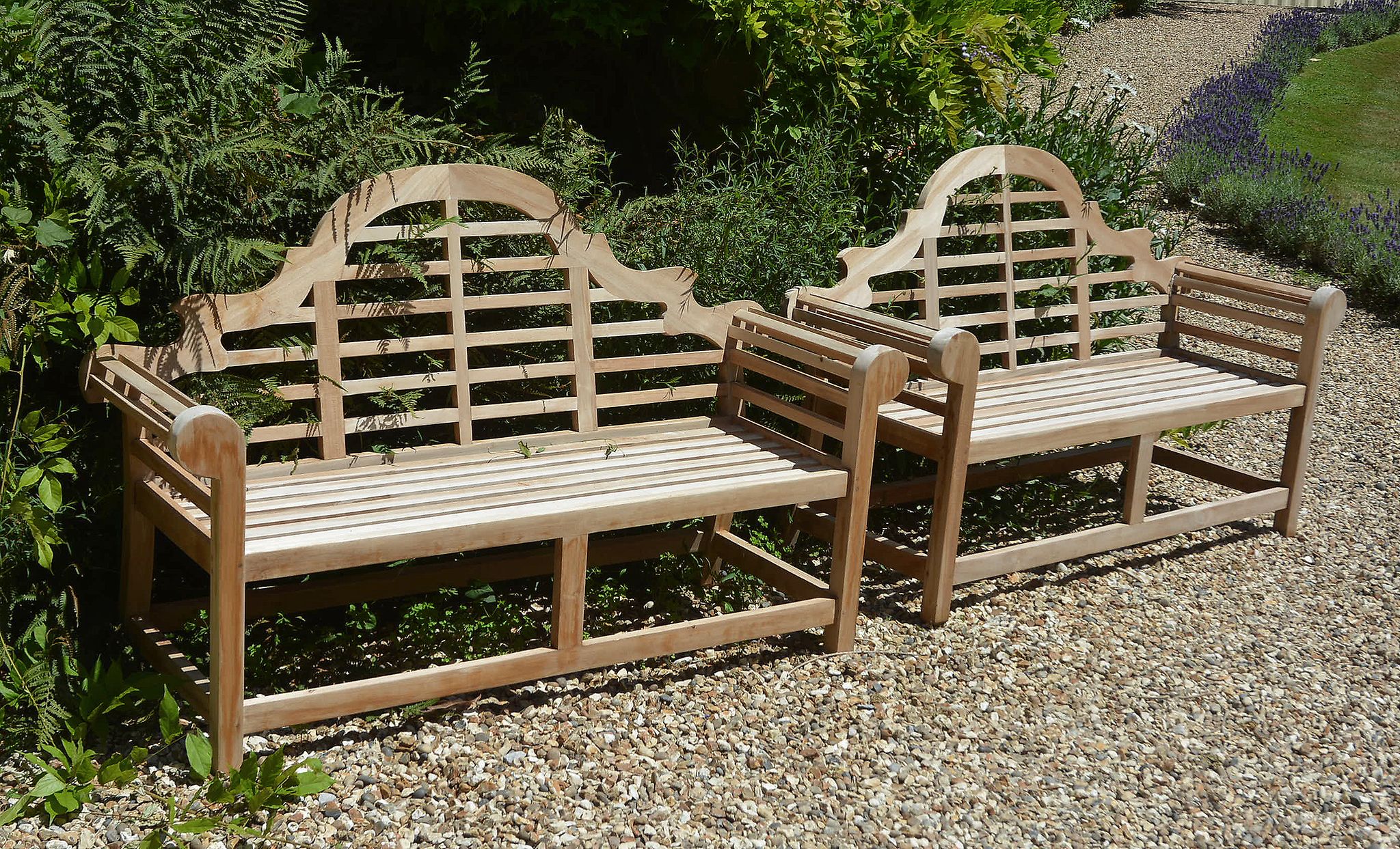 A pair of teak garden seats in the manner of designs by Lutyens A pair of teak garden seats in the