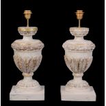 A pair of carved, painted and parcel giltwood urns fitted as table lamps, 20th century, with