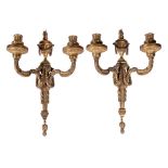 A pair of gilt bronze twin light wall appliques in Louis XVI style, early 20th century, with fluted