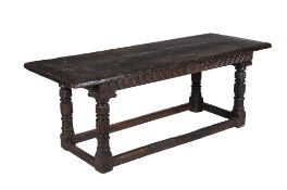 An oak refectory table , 17th century and later elements, on acanthus carved 'cup and cover'