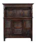 A Charles II panelled oak press cupboard, Westmorland, circa 1660, the moulded cornice above the