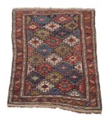 A Caucasian rug, the navy field decorated with polycrome geometric motifs, approximately 172 x
