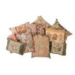 A collection of eight cushions , including one with antique tapestry fragment, the others with