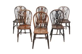 A harlequin set of six elm, beech and fruitwood wheelback dining chairs, first half 19th century,