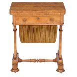 A Victorian maple work table , circa 1860, the top opening and revolving, above single frieze