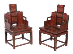 A pair of Chinese lacquered chairs, the seats each with exterior scene decoration, each 104cm high