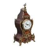 Ω A French gilt brass mounted tortoiseshell veneered mantel clock in the Louis XV taste, retailed by