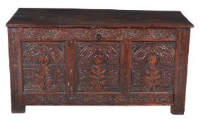 A carved oak and inlaid triple panel coffer , circa 1690, the three panels each centred by a flower