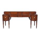 A Scottish George IV mahogany sideboard, circa 1820, the stage back with sliding panels concealing