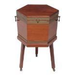 A George III mahogany and brass bound hexagonal wine cooler , circa 1780, with flanking handles to