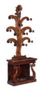A Victorian mahogany hall stand , circa 1860, with dolphin supports to the stick stand, 243cm high,