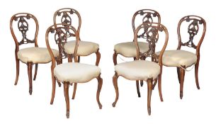 A set of six Victorian walnut dining chairs , circa 1870, each with decorative vertical splat