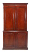 A Victorian mahogany cabinet, circa 1860, the panel doors enclosing fitted interior with