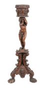 An Italian carved and stained walnut jardiniere stand, mid 19th century, the tapered cylindrical