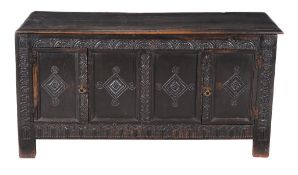 An oak panelled coffer , circa 1660 and later, the front panels later adapted to doors, 68cm high,