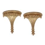 A pair of carved and giltwood wall brackets in early 19th century taste, 20th century, the demi-