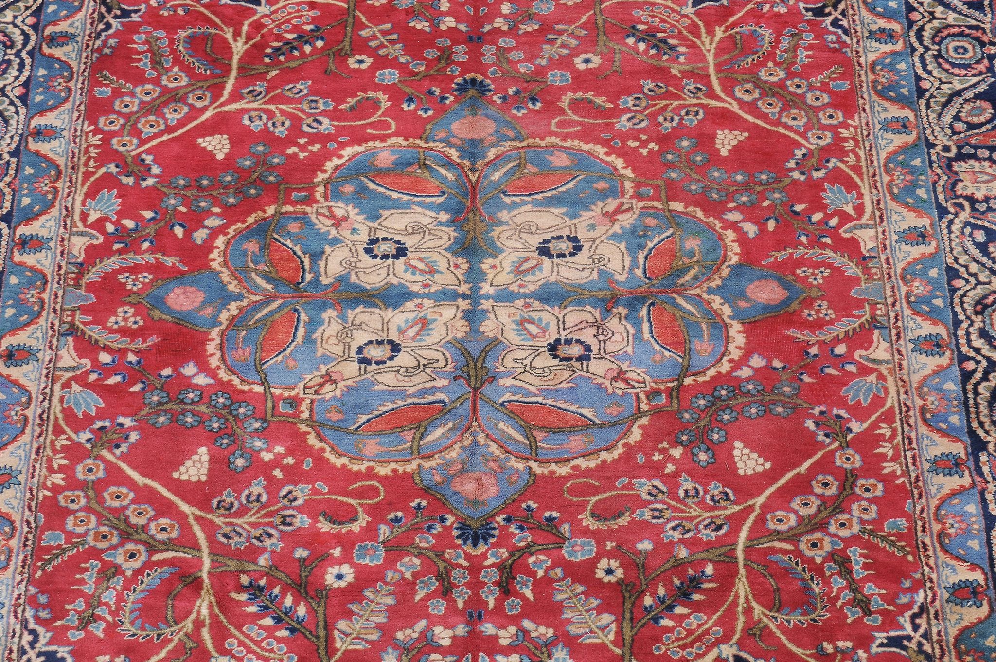 A Kashan carpet , the red field decorated with floral trees and foliage and centred by a sky blue - Image 2 of 2