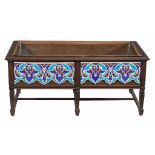 An Arts and Crafts hardwood and tiled planter , circa 1900, the hardwood frame enclosing copper