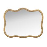 A Continental giltwood wall mirror, late 19th century, of cartouche form, the plate within a