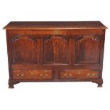 A George III oak mule chest , circa 1780, with three shaped panels above two short drawers and ogee