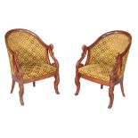 A pair of carved beech tub armchairs in Empire style , late 19th/ early 20th century, each with a