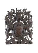 A carved and stained wood armorial panel, early 19th century, showing the arms of Great Britain and