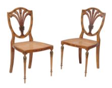 A pair of Sheraton Revival painted satinwood chairs , circa 1900, each with rattan seat