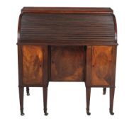 A George III mahogany and inlaid desk, circa 1800, the rectangular top above the sliding tambour