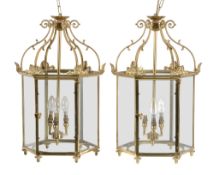 A pair of gilt metal and glazed hall lanterns, 20th century, of hexagonal section, each with six