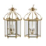 A pair of gilt metal and glazed hall lanterns, 20th century, of hexagonal section, each with six