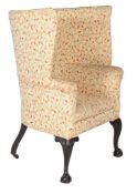A mahogany and upholstered wing armchair, in George II style, first half 19th century, 124cm high,