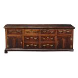 An oak, walnut and inlaid dresser base , mid 18th century, the oak top above an arrangement of