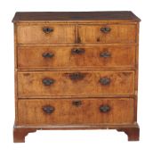 A George II walnut chest of drawers , circa 1740, with two short and three long graduated drawers,