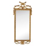 A carved giltwood wall mirror , circa 1800 with torches and festoon surmounting the rectangular