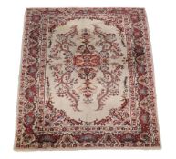 A Tabriz carpet, the cream field profusely decorated with flowerheads and foliage in tones of red,