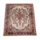 A Tabriz carpet, the cream field profusely decorated with flowerheads and foliage in tones of red,