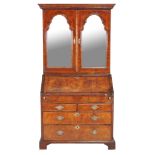 A walnut bureau bookcase , circa 1715 and later, the mirrored doors enclosing adjustable shelves,